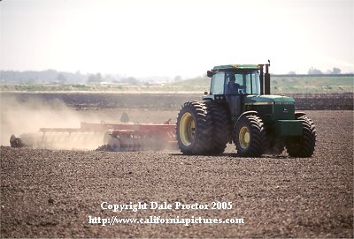 Farming, plowing field for crops, tractor photo