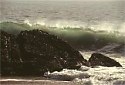 big waves curl spray water edge of rock west coast